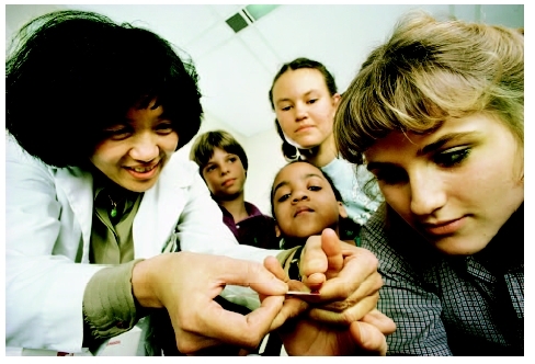 Diabetic children learning how to monitor glucose levels with a blood test. ( Roger Ressmeyer/Corbis.)