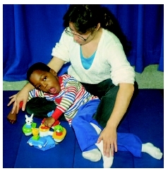 Young boy with cerebral palsy works with a physical therapist. ( Custom Medical Stock Photo, Inc.)