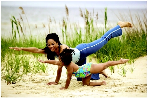 Mother and daughter practicing yoga. ( Ariel Skelley/Corbis.)