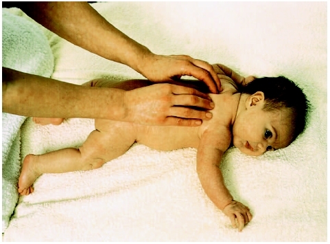 Infant receiving a massage. ( Photo Researchers, Inc.)