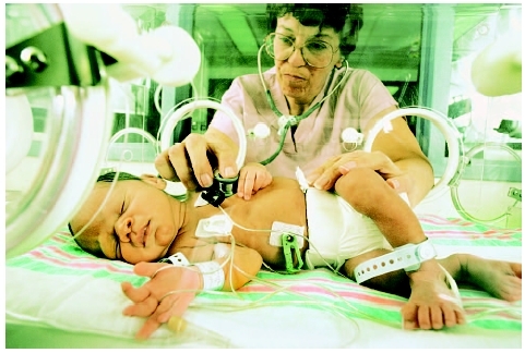 Premature infant in an incubator. ( Royalty-Free/Corbis.)