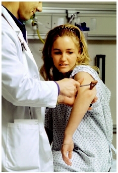 Doctor performing a reflex test on a young girls elbow. (Photo Researchers, Inc.)