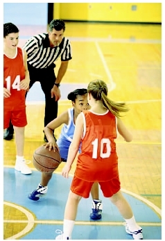 Children participating in a basketball game. ( Tom  Dee Ann McCarthy/Corbis.)